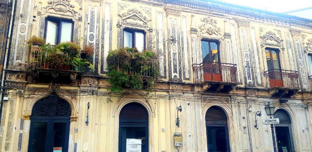 a building with balconies and potted plants on it at Gli appartamenti del Casino dei Civili in Trecastagni