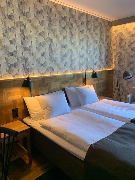 Postel nebo postele na pokoji v ubytování Nybro Stora Hotellet