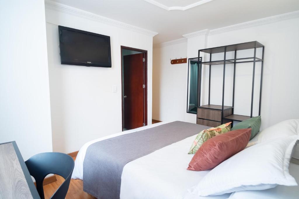 Postel nebo postele na pokoji v ubytování Hotel Virrey Central