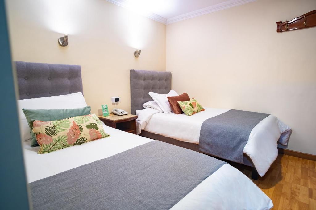Postel nebo postele na pokoji v ubytování Hotel Virrey Central
