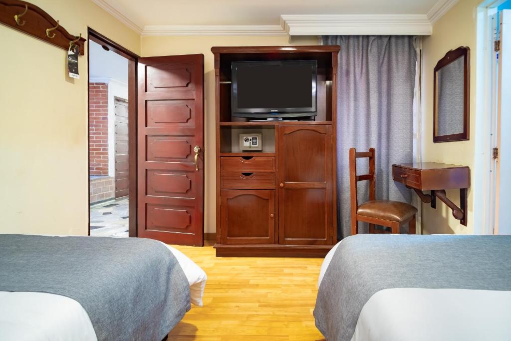 Postel nebo postele na pokoji v ubytování Hotel Virrey Central