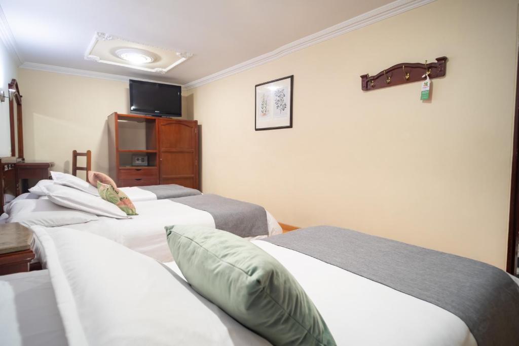 Postel nebo postele na pokoji v ubytování Hotel Virrey Central