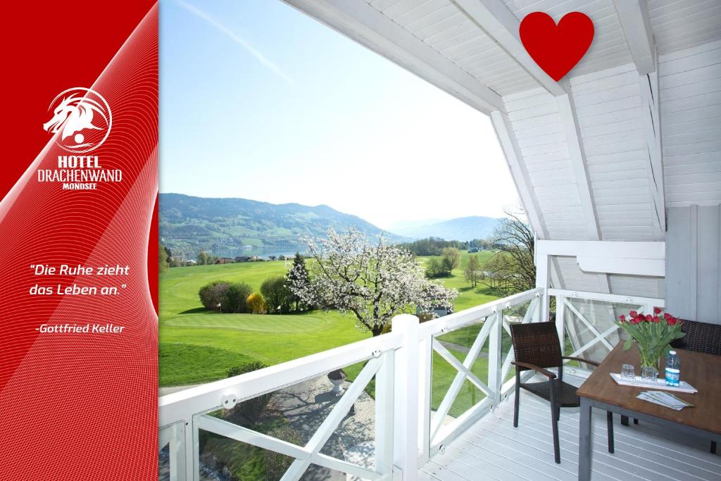 a banner for a house with a view of a golf course at Hotel Drachenwand-Mondsee in Mondsee