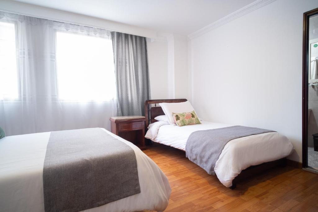 Postel nebo postele na pokoji v ubytování Hotel Virrey Central