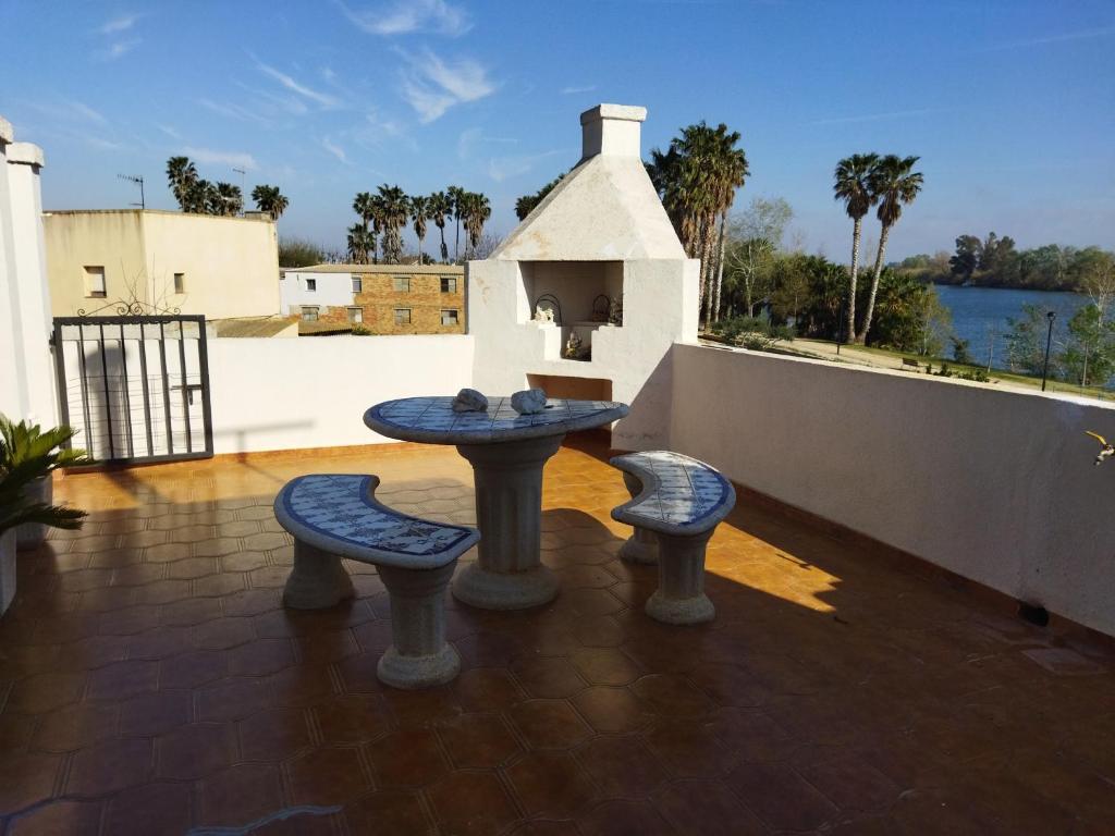 a patio with a table and two chairs and a table at Casa Joan de l'Illa in Deltebre