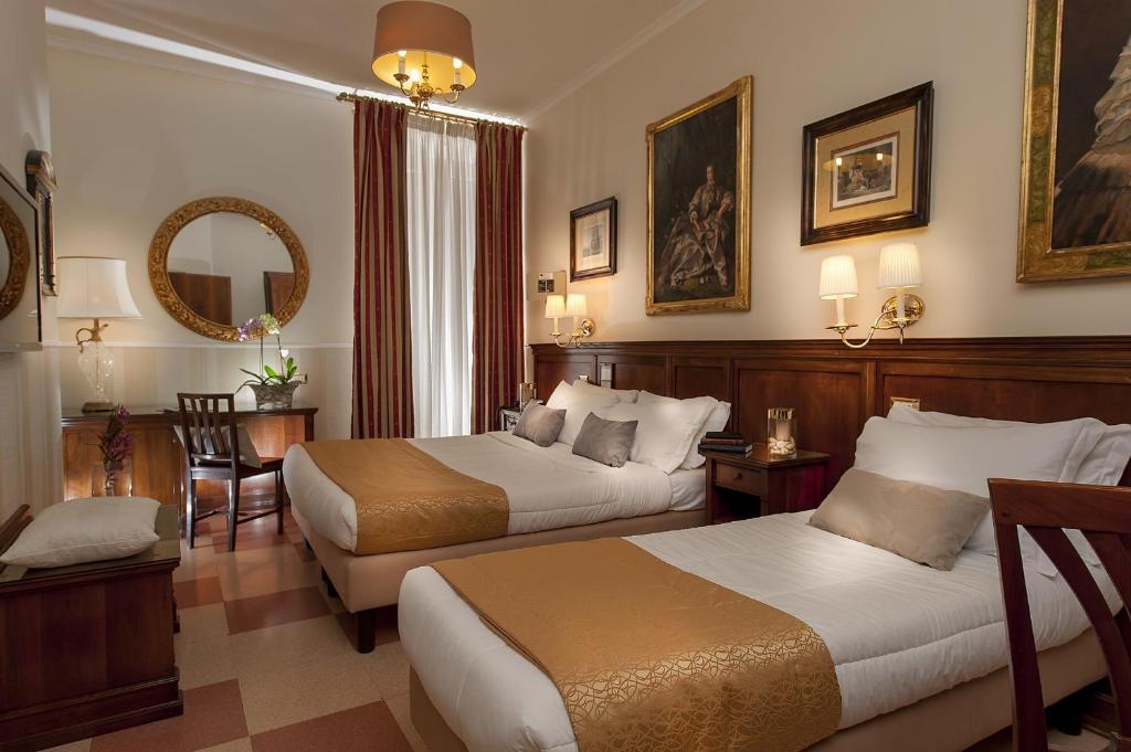 Postel nebo postele na pokoji v ubytování Hotel Des Artistes Roma