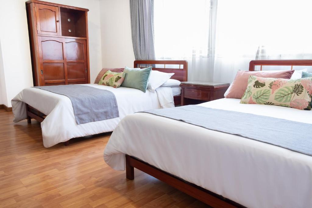 Postel nebo postele na pokoji v ubytování Hotel Virrey Central