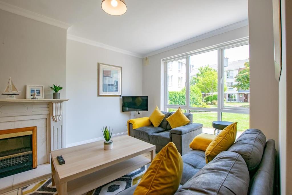 a living room with a couch and a fireplace at 103 - The Townhouse at Gort na Coiribe by Shortstays in Galway