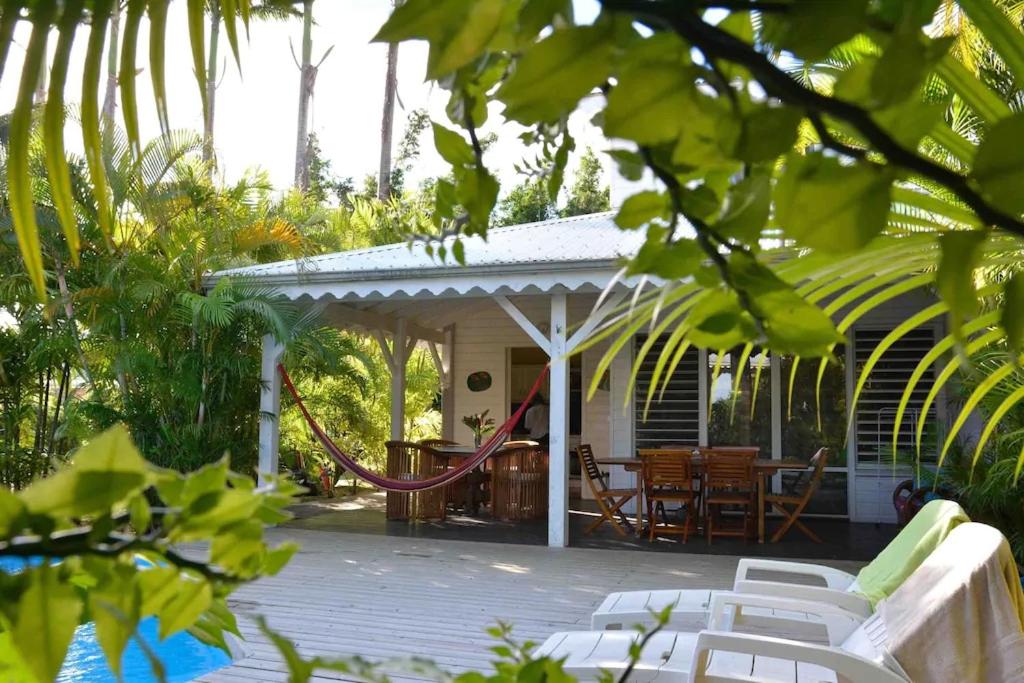 a porch with a gazebo with chairs and a table at Villa Van Gogh aux Aquarelles in Sainte-Rose