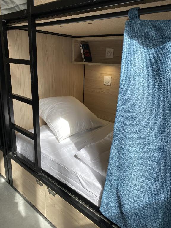 Un ou plusieurs lits dans un hébergement de l'établissement YASI Hostel