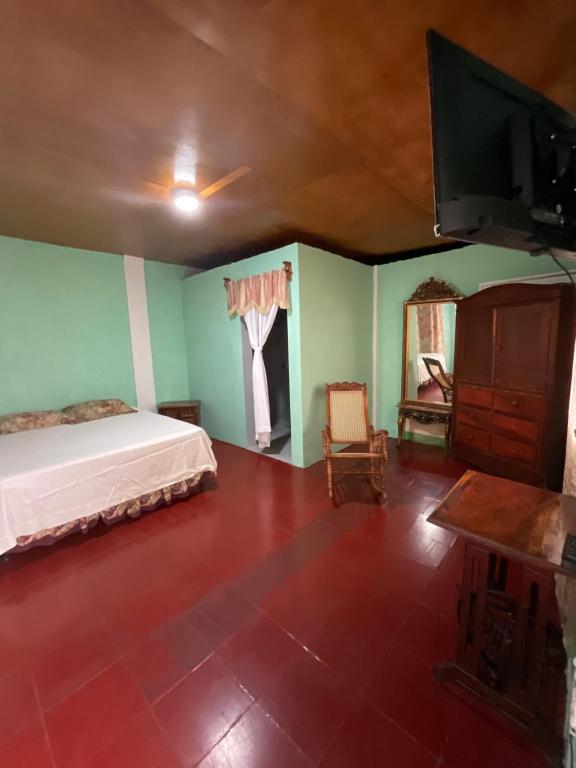 a bedroom with a bed and a flat screen tv at Hostal Familiar in Granada