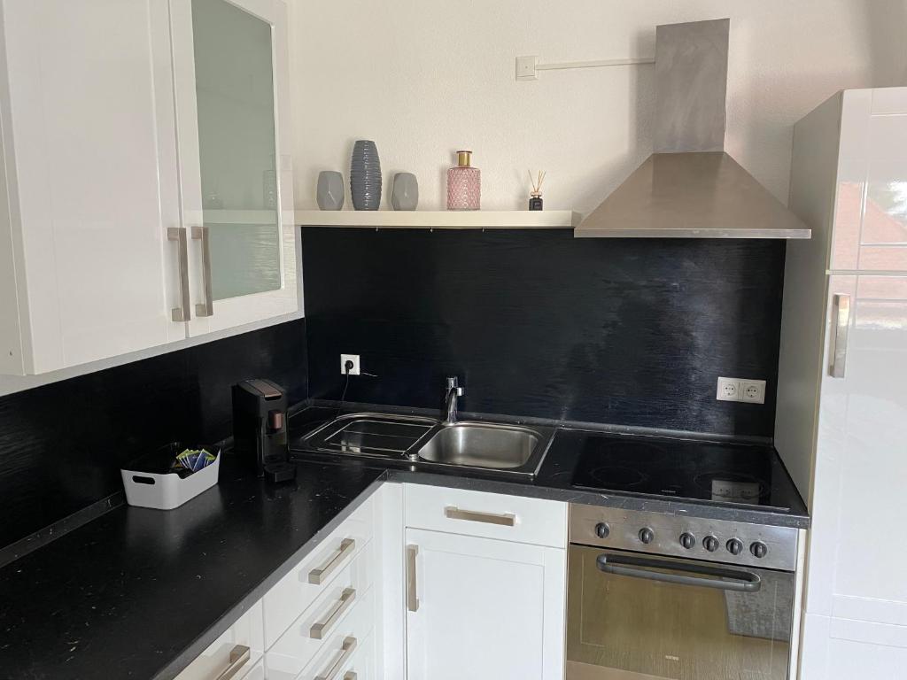 a kitchen with a sink and a stove at 1 Zimmer Wohnung mit Bad in Trossingen