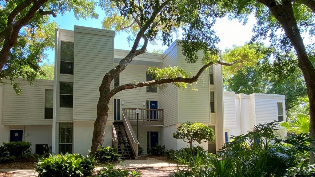 an exterior view of a building with trees at Villas by The Sea Three Bedroom Apartment in Jekyll Island