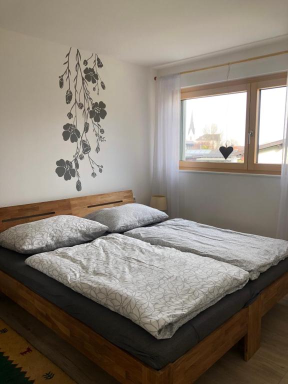 a bed in a bedroom with a window at Apartments "Am Ardetzenberg" in Feldkirch