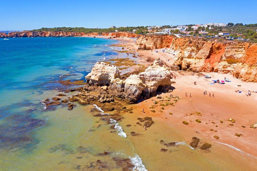 an aerial view of a beach with rocks and the ocean at Seaview, beach front, studio in Alvor