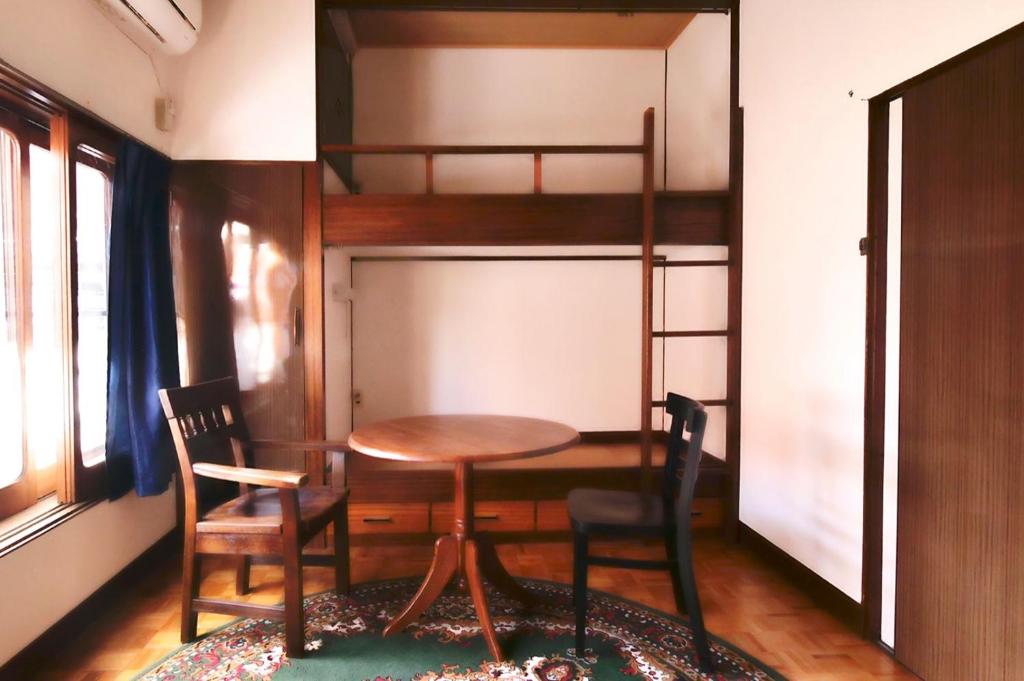 a dining room with a table and a bunk bed at fumoku - Vacation STAY 12915v in Chino