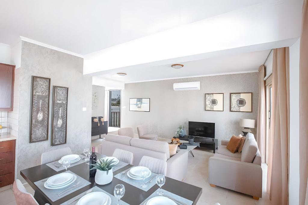 a living room with a couch and a table at Blue Crystal Seaview in Protaras