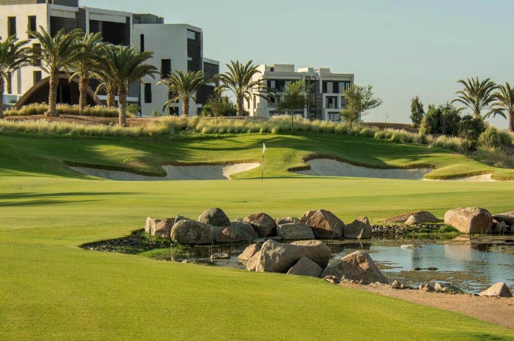 a golf course at the resort with a pond at Ayla and chill Restricted to families and couples only in Aqaba