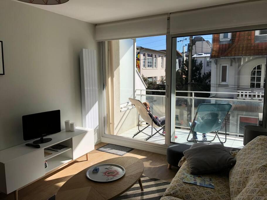 a living room with a view of a balcony at Mayfair in Le Touquet-Paris-Plage