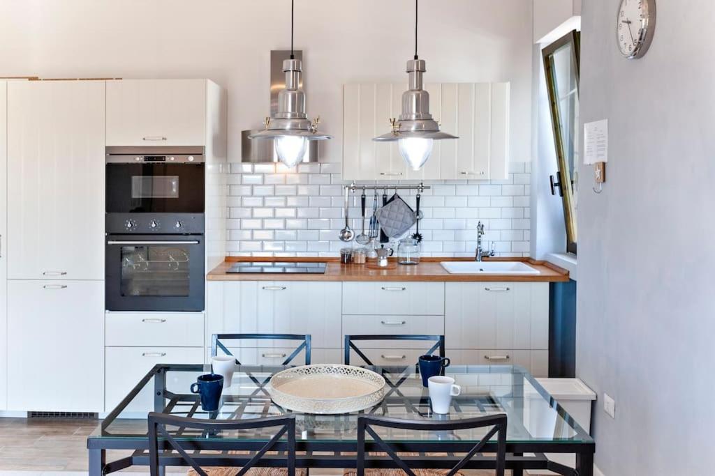 A kitchen or kitchenette at Cozy Flat and Terrace - 2 min from the beach by Sweet Home Puglia Apartments