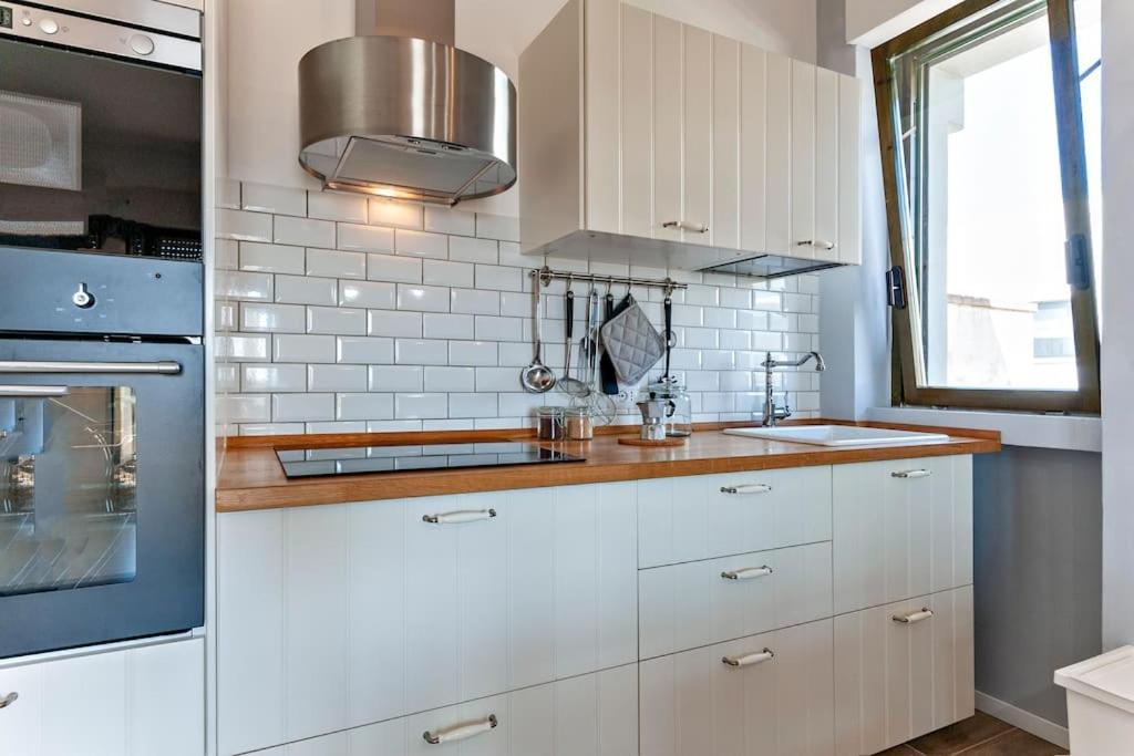 A kitchen or kitchenette at Cozy Flat and Terrace - 2 min from the beach by Sweet Home Puglia Apartments