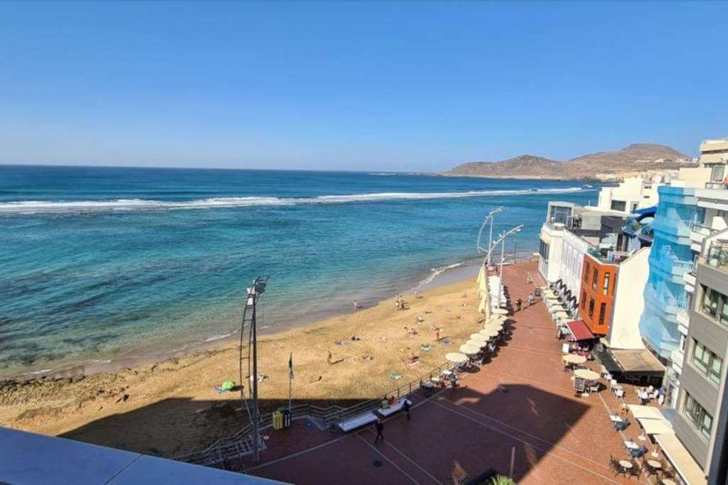 a view of a beach and the ocean with buildings at VV El Camarote de Playa Chica ¨by henrypole home¨ in Las Palmas de Gran Canaria