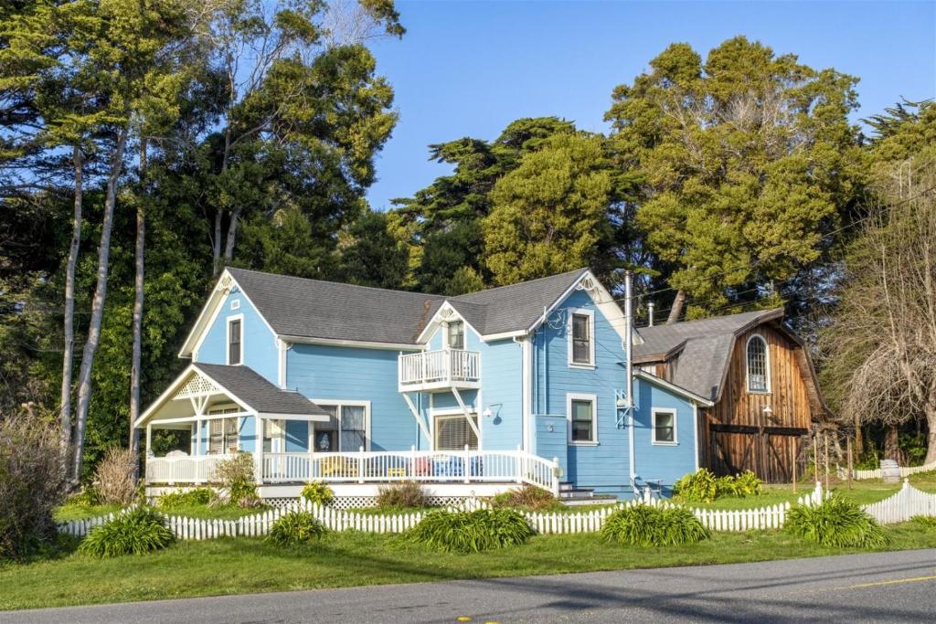 a blue house on the side of the road at A - Annie`s Beach House in Fort Bragg