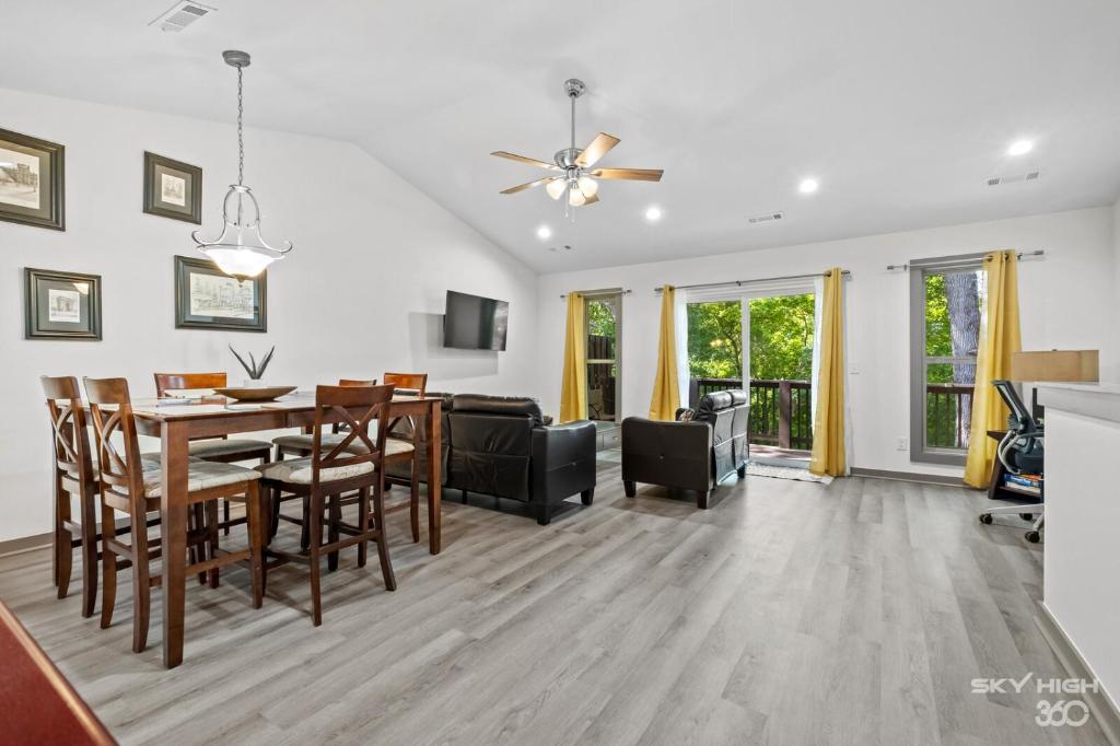 a dining room and living room with a table and chairs at Alyce Retreat - Nature, Trails and Lake Escape in Bella Vista
