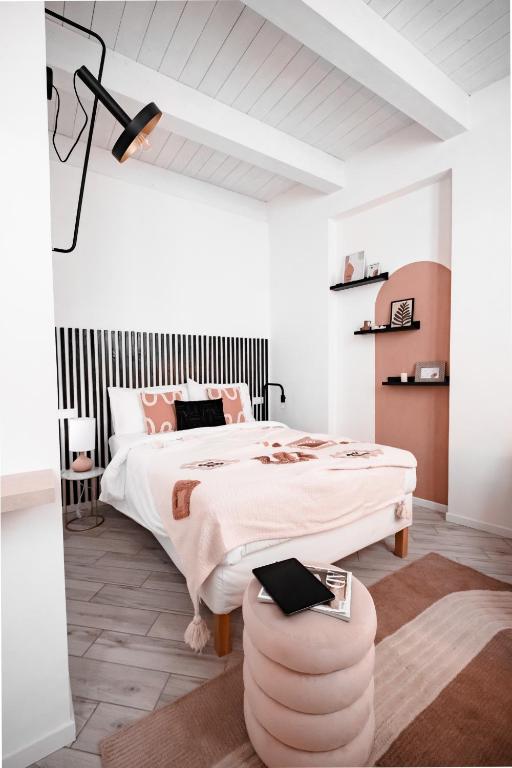 a bedroom with a large bed and a table at HYGGE APT - FERRARA CENTRO in Ferrara