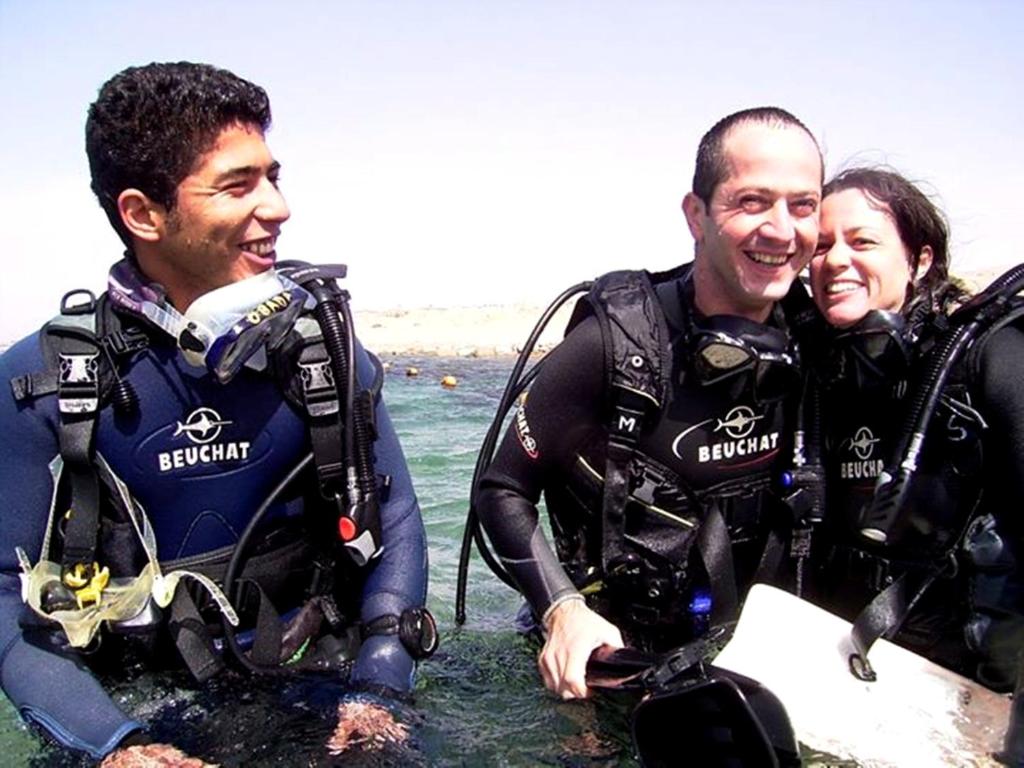 a group of three people in the water at Arab Divers Dive Center and Bed & Breakfast in Aqaba