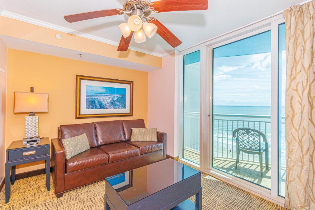 a living room with a couch and a balcony at Towers On The Grove 724 Direct Oceanfront Suite Sleeps 6 guests in Myrtle Beach