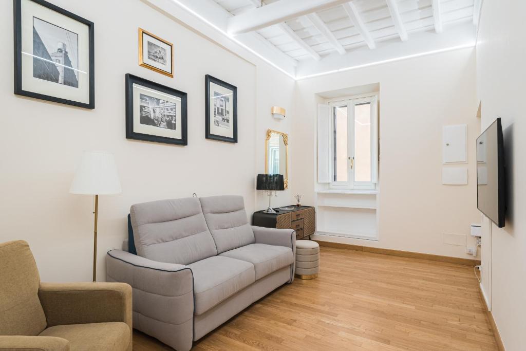 ein Wohnzimmer mit einem Sofa und einem TV in der Unterkunft Lupa Luxury Apartment in Rom