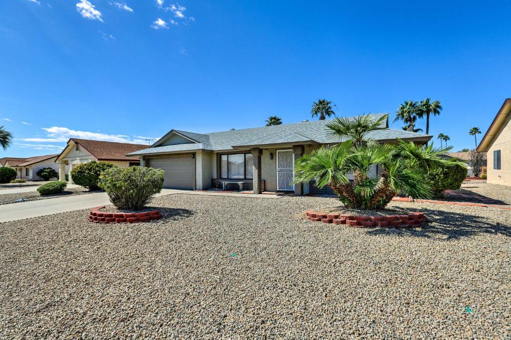 a house with two palm trees in a driveway at Less Than 1 Mi to Golf Home with Screened Porch in Sun City in Sun City West