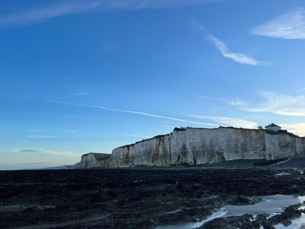 a large cliff sitting next to a body of water at Parc Beausejour Aparthotel in Dieppe