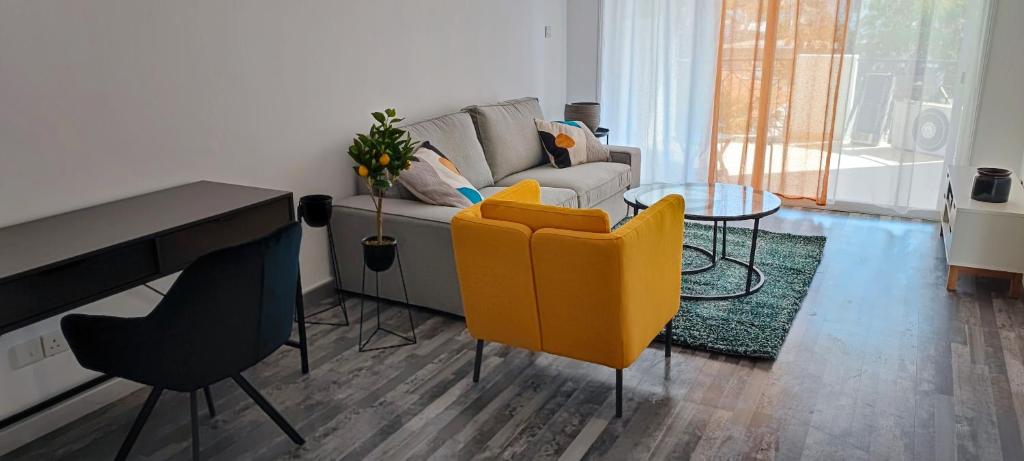a living room with a couch and a table at Zinas modern flat Nicosia in Strovolos