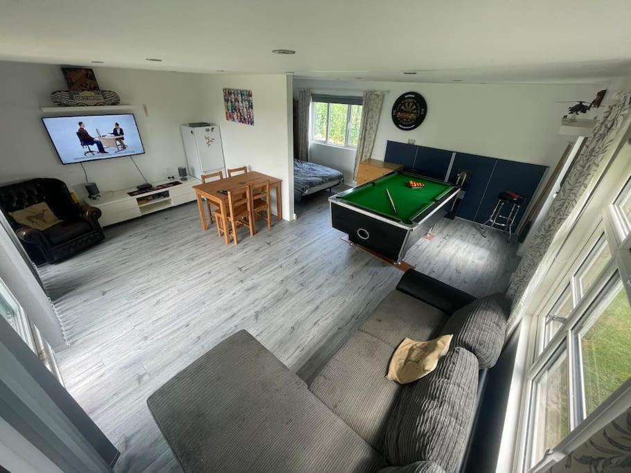 an overhead view of a living room with a pool table at Bus and the lodge With space and views in Bladon