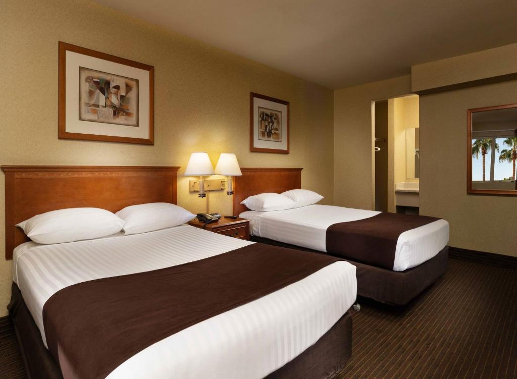 a hotel room with two beds and two lamps at Arizona Charlie's Boulder in Las Vegas