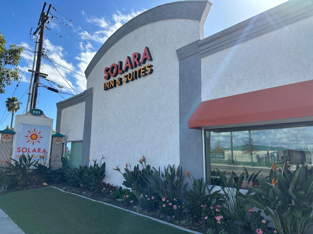 a santa ana inn and suites sign on the side of a building at Solara Inn and Suites in Anaheim