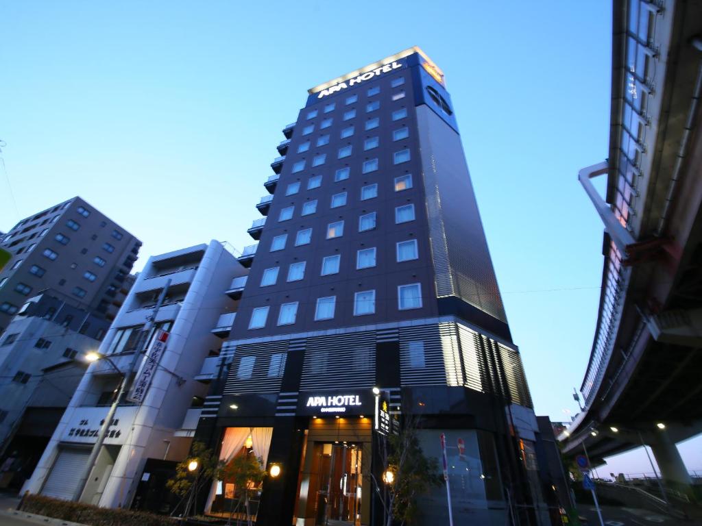 a tall building with a clock on the side of it at APA Hotel Nihombashi Hamacho-eki Minami in Tokyo