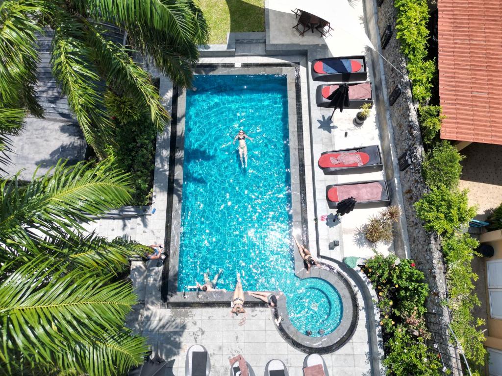 an overhead view of a swimming pool with a man in the water at Baan Heaven / Patong Beach Pool Villa Sleeps up to 15 in Patong Beach