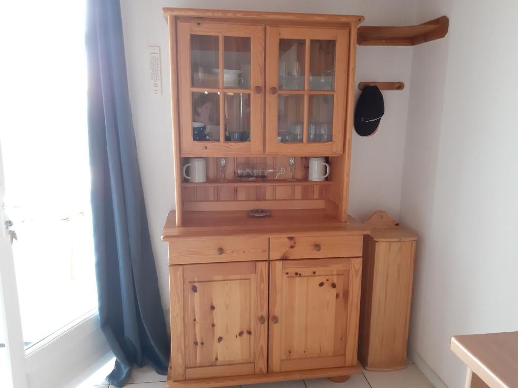 a wooden cabinet in a corner of a room at Maison Jard-sur-Mer, 3 pièces, 5 personnes - FR-1-485-78 in Jard-sur-Mer