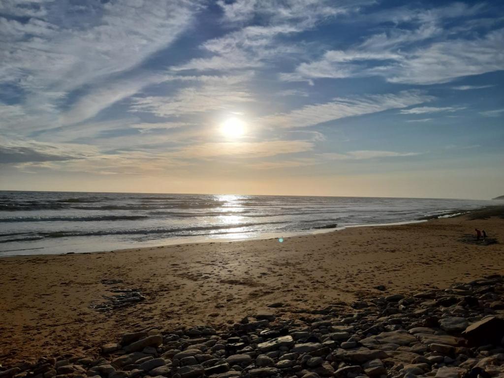 a beach with the sun rising over the ocean at Maison Jard-sur-Mer, 3 pièces, 5 personnes - FR-1-485-78 in Jard-sur-Mer