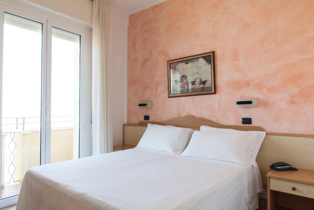 Postel nebo postele na pokoji v ubytování Hotel Palos