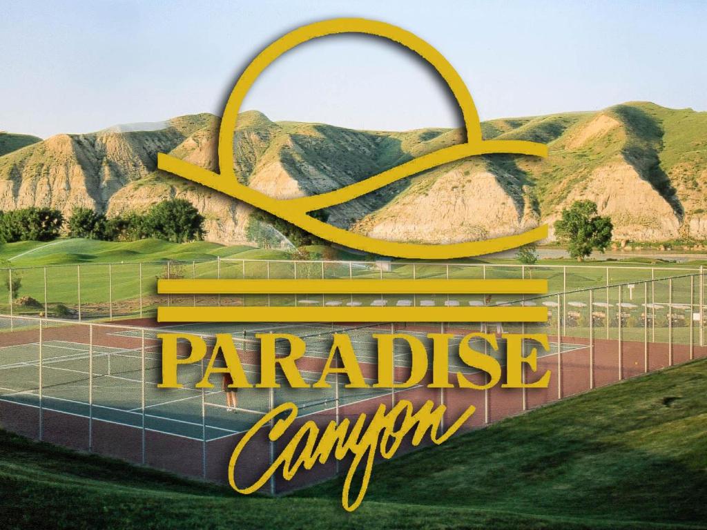 a sign with the olympic rings in front of a tennis court at Paradise Canyon Golf Resort, Luxury Villa 409 in Lethbridge