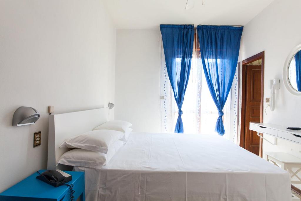 Postel nebo postele na pokoji v ubytování Hotel Palos