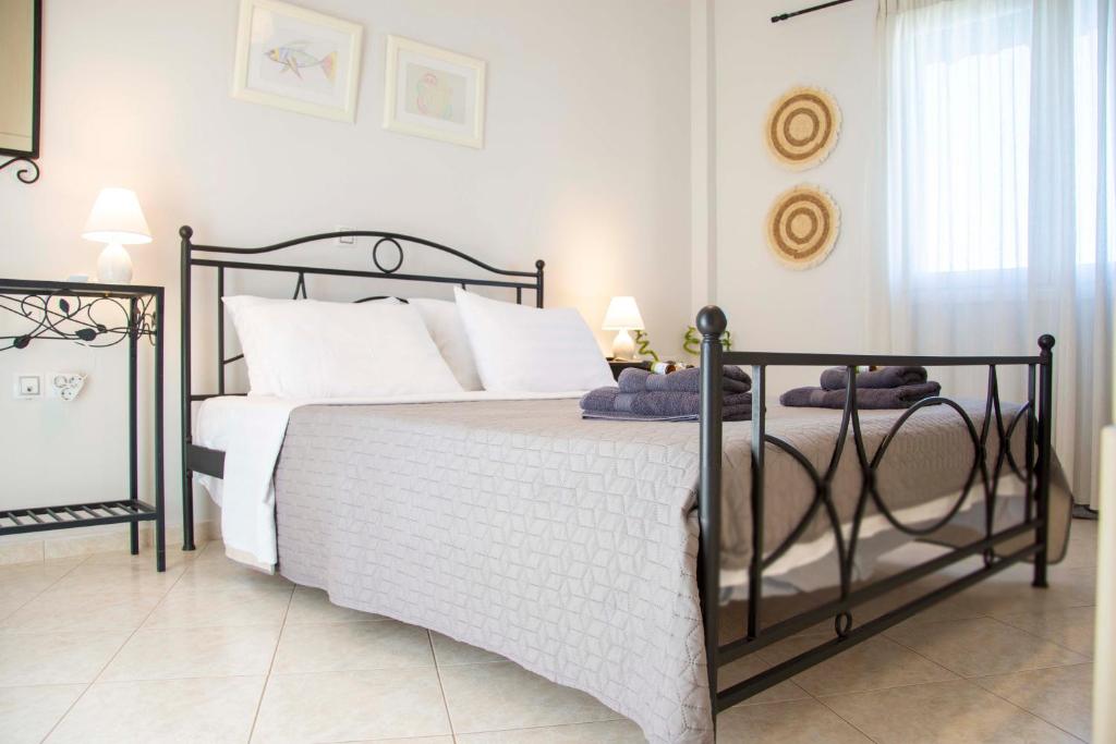 a bedroom with a black and white bed and a window at Perdika Sea Soul in Perdika