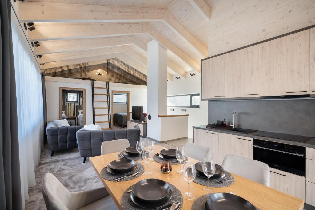 a kitchen and dining room with a table and chairs at Chalet Pod Brdom - Apartments in Ružomberok