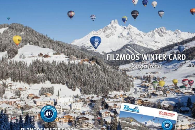 a bunch of hot air balloons flying over a snowy mountain at Apartment in Filzmoos with a balcony in Filzmoos