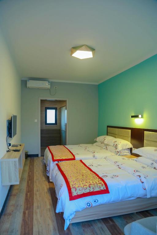 Postel nebo postele na pokoji v ubytování Beidaihe No. 3 Jinhai
