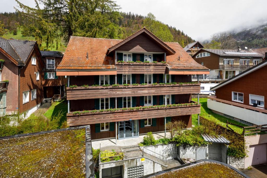 ein großes Haus mit Balkon in einem Dorf in der Unterkunft Hirschen Guesthouse - Village Hotel in Wildhaus